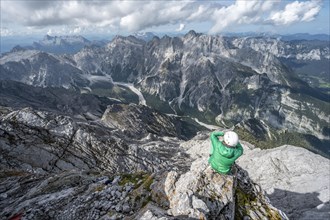 Hiker with helmet at the summit of the Watzmann