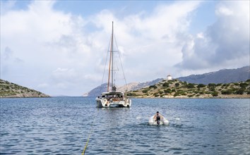 Sailing catamaran in Panormitis Bay