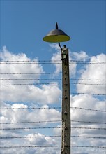 Barbed-wire fence and lamp-post at Auschwitz II-Birkenau concentration camp