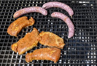 Barbecue grill with steaks and sausages
