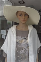 Female mannequin with large straw hat