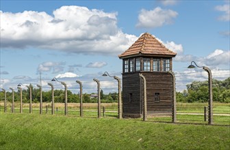 Barbed-wire fence and watch-tower at Auschwitz II-Birkenau concentration camp