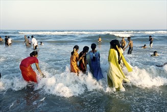 Women bathing in colorful saris