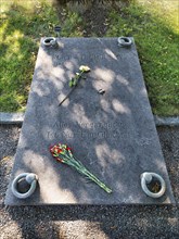 Gravestone with flowers and inscription