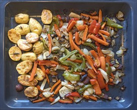 Rosemary potatoes and mixed vegetables on a baking tray