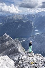 Hiker with helmet at the summit of the Watzmann middle peak