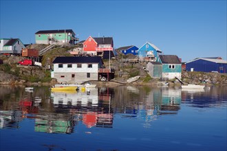 Colourful houses reflected in the fjord