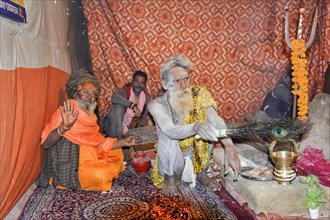 Sadhu covered with white ash in tent