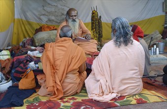 Pilgrims gather and meditate in a tent