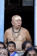 An old brahmin man watching the Arupathumoovar festival