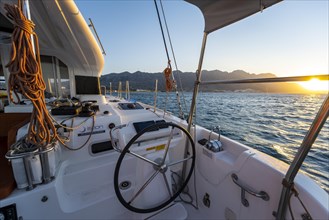 Steering wheel in the cockpit on deck of a sailing catamaran