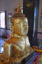 Buddha statue covered with gold leaf