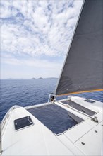 Foresail and deck with net of a sailing catamaran