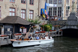 Excursion boat on a canal in the historic centre of the old town of Bruges