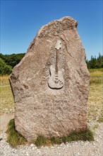 Memorial stone with inscription and relief of an electric guitar by Jimi Hendrix