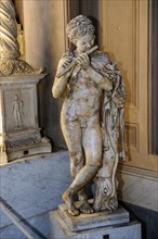 Statue in marble of child playing the flute