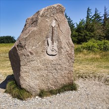 Memorial stone with inscription and relief of an electric guitar by Jimi Hendrix