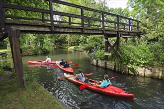 Tourists paddle through the village of Lehde