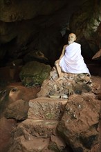 Sitting statue of a monk