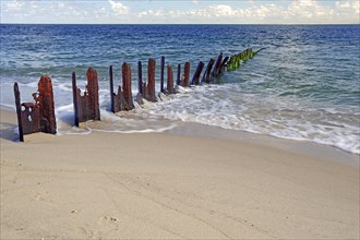 Old steel groynes on the beach at the elbow