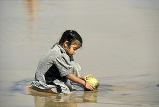 A girl playing on the beach