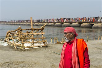 Pilgrims cross the Ganges on a makeshift pontoon bridge