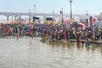 Pilgrims waiting to step into the Ganges for ritual bathing