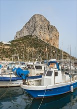 Boats and yachts at Calp (Calpe) harbor and Penyal d'Ifac rock