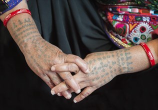 Tattooed arms and hands of a woman