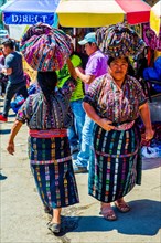 Market woman with wrap skirt and colourful embroidered blouse