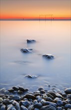 View from Arbon over Lake Constance at sunrise with stones in the foreground