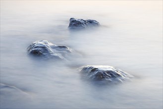 Stones in water photographed with slow shutter speed