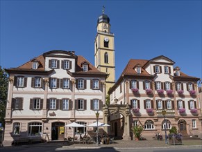 Twin houses and church tower of St. John's Minster on the market square in Bad Mergentheim