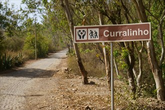 Paved road and town sign Curralinho