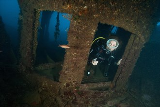 Diver looking out of window of bridge of Canadian ship Mohawk Deer sunk off Portofino