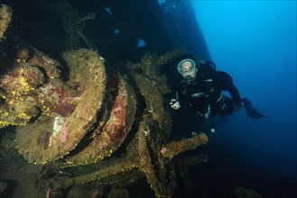 Diver looks at anchor winch encrusted with marine organisms from Canadian ship Mohawk Deer sunk off Portofino