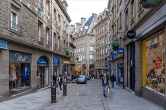 People shopping with masks in the empty streets of the old town of Saint Malo