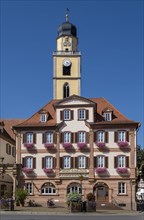 Twin house and church tower of St. John's Minster on the market square in Bad Mergentheim