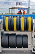 Mobile rack with racing tyres in protective cover for car racing