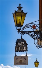 Sign from the Ratskeller and lamp