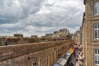 View from the city wall into an alley of the old town with colourful awnings of Saint Malo