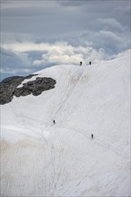 Hiker on old snow field