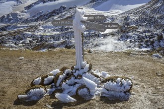Snow-encrusted signpost above the Hveradalir hot spring area
