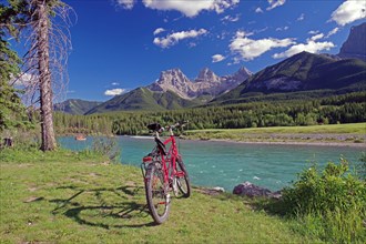 Bicycle in front of river and mountains
