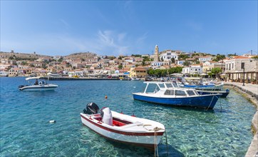 Fishing boats in the harbour of Halki with turquoise water