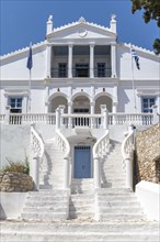White noble mansion with curved stairs