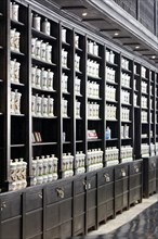 White ceramics with essences and ingedences on the shelf of old pharmacy