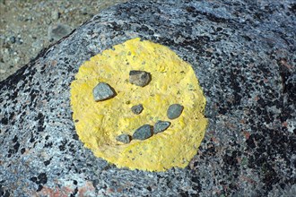 Face of yellow paint on stones