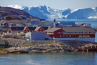 Buildings in front of icebergs