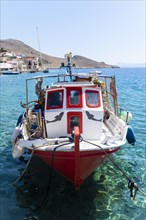Fishing boat in Halki harbour with turquoise blue water